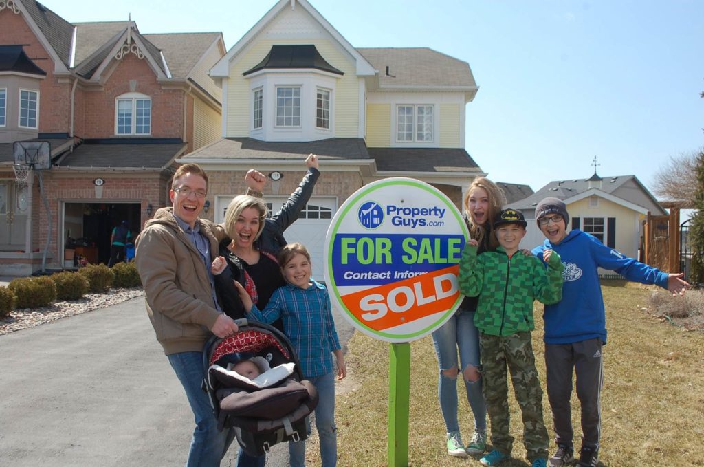 propertyguys.com franchise family in front of sold house